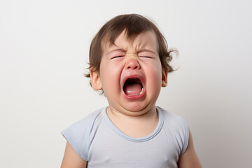 a closeup photo of a cute little baby boy child crying and screaming