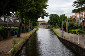 Fototapeta na wymiar Overschie, South Holland, The Netherlands - View over the river Schie, houses and green surroundings