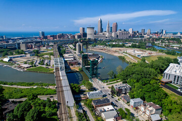 An aerial view of downtown Cleveland, Ohio with the Cuyahoga River in snaking through, including the rail lift brifge.