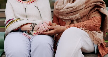 Senior friends, park and holding hands with support, comfort and hope outdoor. Bench garden sitting and mature people with retirement, empathy and kindness gesture for friendship and trust together