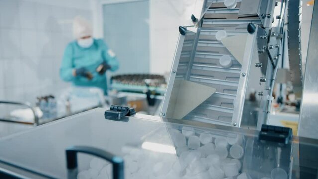 Feeding conveyor for transporting products to the filling and packaging machine. Transportation of products to the packaging machine. Production line of medical dietary supplements. Pharma factory
