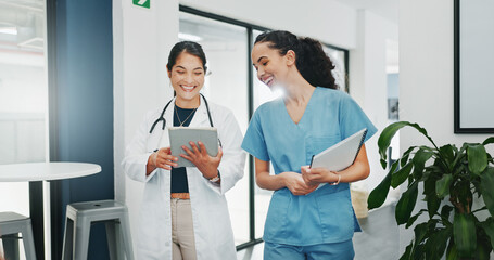 Talking doctor, walking or nurse on tablet in busy hospital teamwork, women collaboration or...