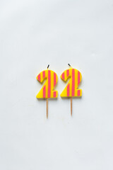 top view of number candles, number 22 candle on a white background, birthday candles on white...