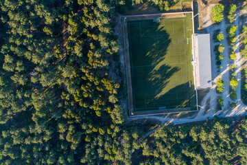 aerial overhead view of a soccer field in a pine forest - obrazy, fototapety, plakaty