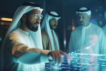 Fotobehang Arabian businessman working on new project with his team, touching hologram display while checking digital information in modern office. © Bojan