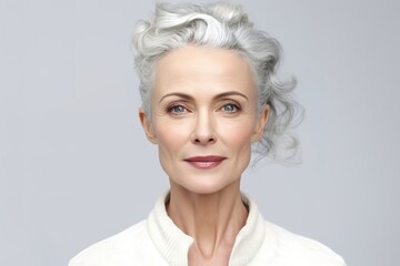 Fototapeta premium Headshot portrait of gorgeous middle aged mature woman. Female senior between 50 and 60 years old looking at camera.