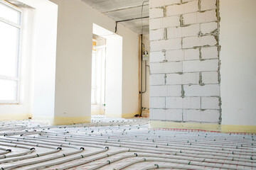 System of underfloor heating, work in progress on a construction site for a flat residence building