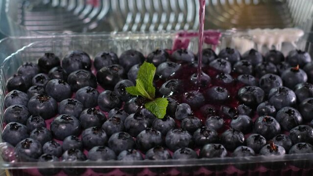 cooking jelly cakes with berries at home pour layers of delicious dessert beat in a blender. smooth with a tablespoon in a plastic container delicious dessert pour blueberry jelly mousse