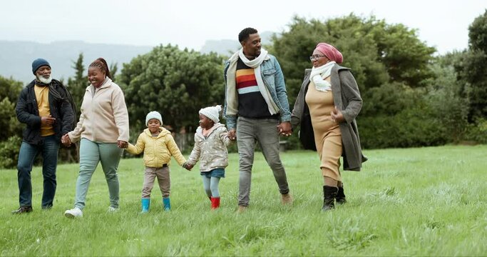 Grandparents, black family or children holding hands in park or nature outdoors in countryside together. Grandfather, grandmother or dad walking, bonding or enjoying holiday vacation with kids or mom