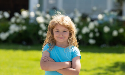 Little child play on summer backyard. Lifestyle portrait of cute kid outdoors. Summer kids outdoor portrait. Close-up face child playing outdoors in summer park.