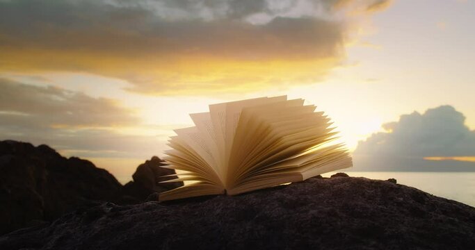 Scriptures on pages of open book at sunset. Rocky lifeless planet. In the begining there was the word, and the word was with God.