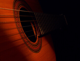 Acoustic guitar with dark background and thin light stream, old fashioned way casette recording