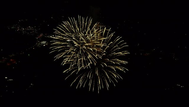 High aerial of explosive fireworks at night in Lake Estes Colorado
