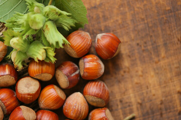  Hazelnuts on a wooden table.Nut abundance. Fresh harvest of hazelnuts. Farmed organic ripe hazelnuts. 