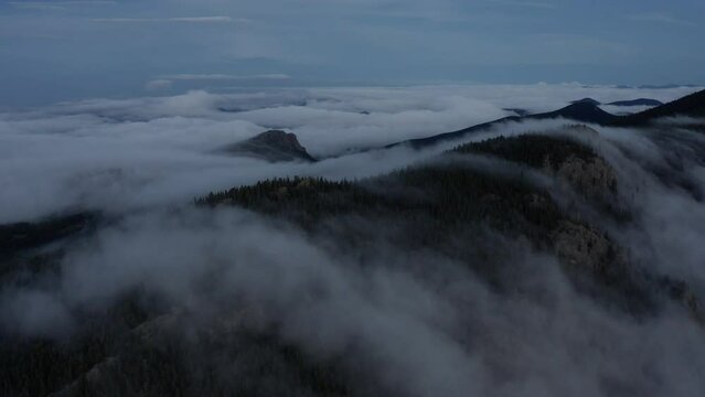 Fog rolls over the mountain peaks in Colorado