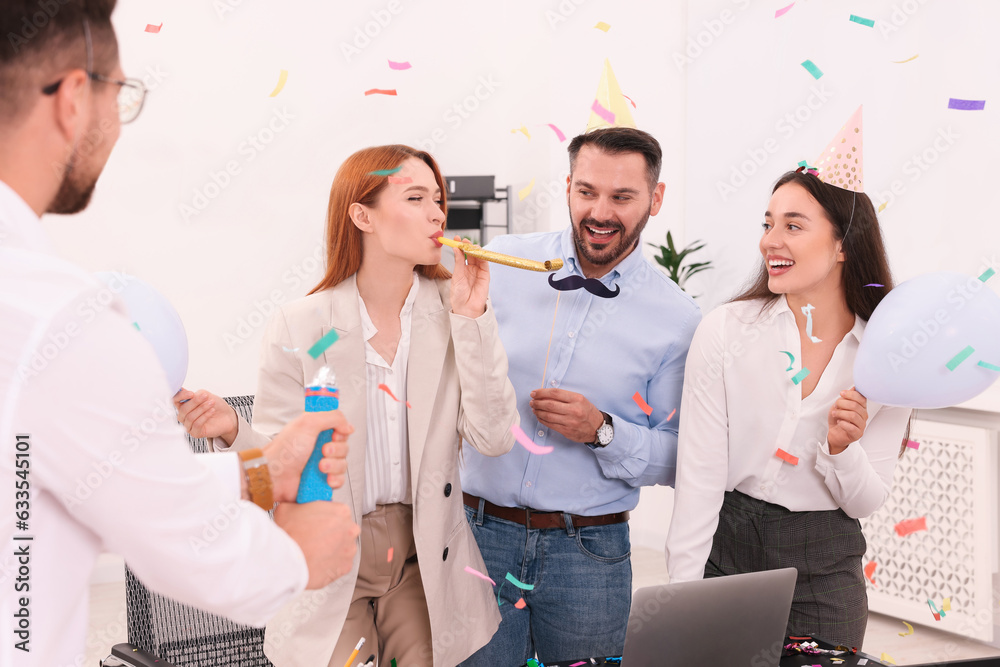 Wall mural Coworkers having fun during office party indoors