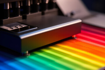 Macro shot of a spectrophotometer analyzing the color and reflectance of a textile sample with bright and vivid hues