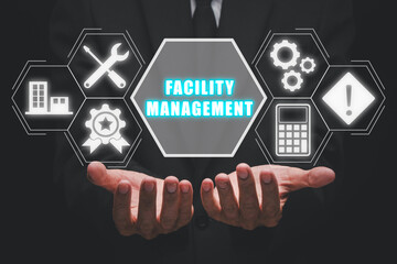 Facility management concept, Business person hand holding facility management icon on virtual...
