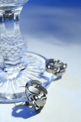 Stylish presentation of elegant earrings on color background, closeup