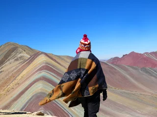 Printed roller blinds Vinicunca Rainbow mountain or seven colors mountain view in the red valley in the andes. Poncho and chullo are the two main dressing peruvian clothes in the picture.