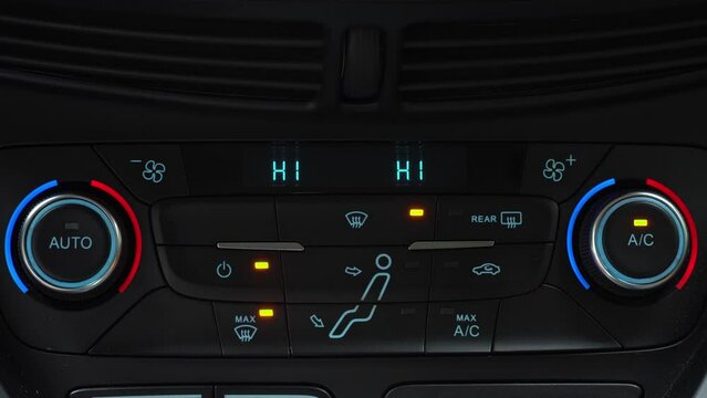 Finger presses button for turning on maximum airflow on the multimedia panel of car, two-phase climate control in the car