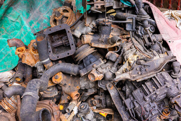 Pile of rusty and dirty obsoleted old vehicle metal engine and spare parts.