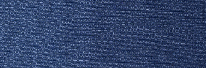 Blue fabric with geometric pattern as background.