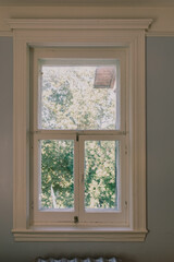 vue de l'intérieur sur une fenêtre résidentielle au cadre blanc en trois sections lors d'une journée ensoleillée