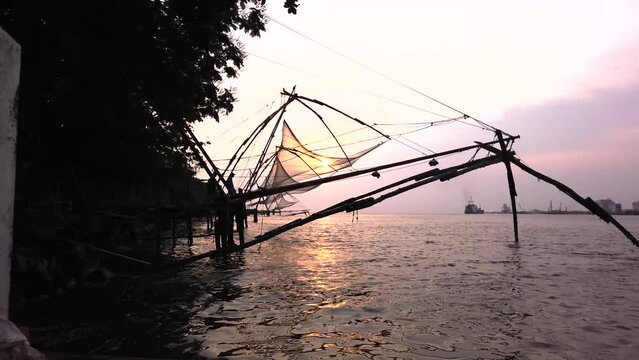  The Chinese Fishing nets Silhouetted against the sunset, built with Teak wood and Bamboo poles work on the principle of balance in Kochi, India.
