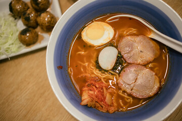 Miso Ramen Asian noodles with pork in bowl on wood background. Japanese cuisine. Top view