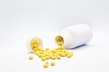 Medicine container with yellow pills for hospitals and sick people on white background