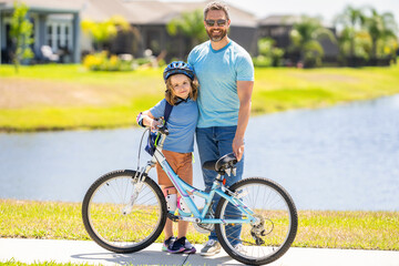 Fototapeta premium father and son promenade. father and son in fatherhood. fatherhood of father and son cycling at sunlit park. father and son navigate the winding paths together at fatherhood. Family bike outing