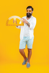 happy man with geometry protractor in studio. man with geometry protractor on background.