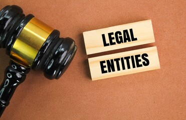 judge gavel and stick to the word legal entities. legal concept or valid law