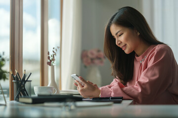 Beautiful businesswoman checking message on smartphone. Communication, connection, technology, business lifestyle concept.