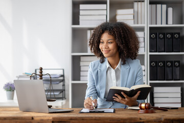 American woman is legal litigation attorney, Female lawyer is in a law firm drafting contracts and...