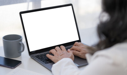 Close up view businesswoman hands typing on keyboard of laptop computer.