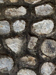 Texture of a garden stone wall. Old garden stone wall texture background. Pattern with vertical natural lines and a grey rough surface in background