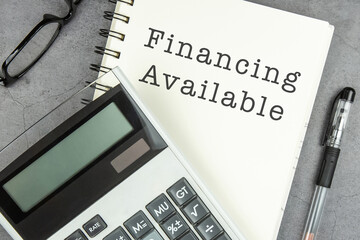 Financing Available text on note pad with calculator