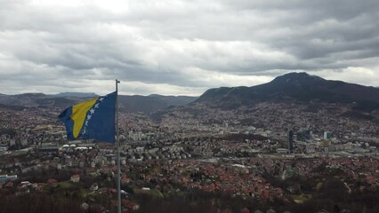 Flag of Bosnia and Herzegovina Flying Above the Capital Sarajevo Aerial Shot 4K