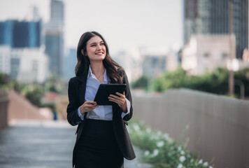 Confident woman leads, showcasing exceptional leadership, strategic thinking, overseeing daily operations with her tablet.