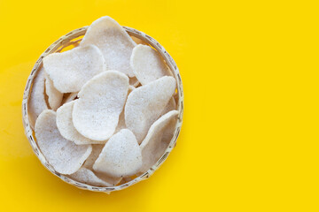 Prawn crackers on yellow background. Shrimp crispy rice snack