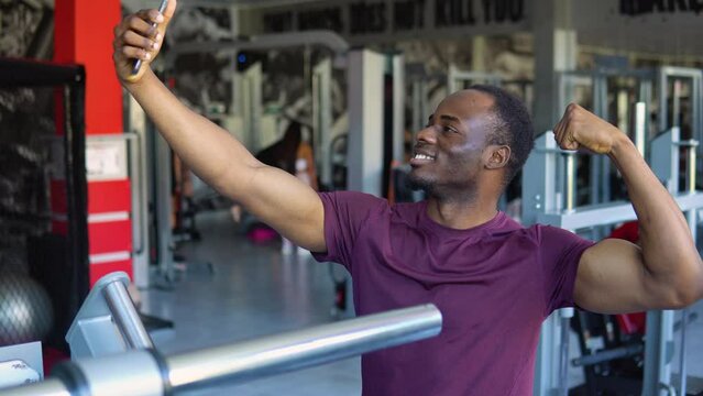 Black man, strong and fitness selfie, gym and exercise portrait, after workout and weight training, happy and flexing arm. Cardio, endurance and smile, sweat for sport and bicep photo, wellness