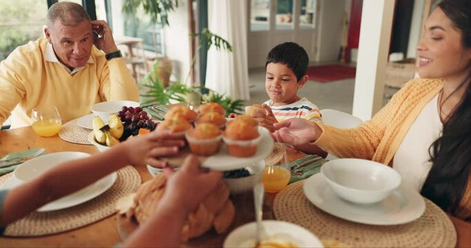 Family, breakfast and cupcakes at table for eating at party, celebration and gathering in home. Brunch, dessert and parents, grandfather and children with muffins for buffet, food and happy together