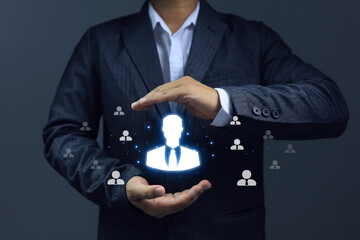 Businessman holding a job candidate in his hand to choose a suitable job for the position. Human...
