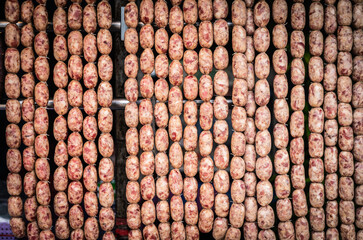 Isaan Sausages, also known as Mum, are both beef and pork hanging on roadsides in the northeastern region of Thailand.