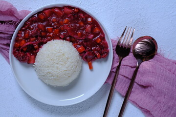 Japanese pink curry with rice on th white round plate. Minced meat curry with natural red dragon...