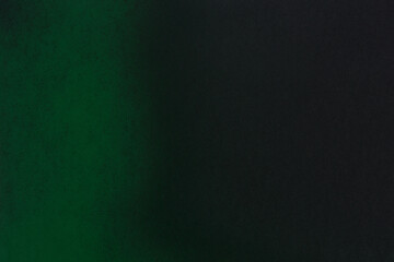 green color spray paint on black color paper
