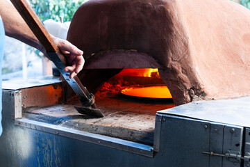Closeup pizza oven glowing hot and cooking