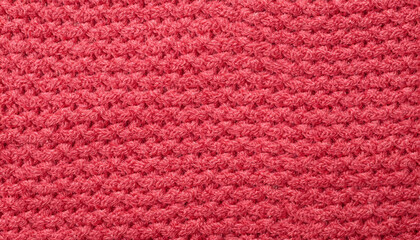 Close up background of knitted wool fabric made of viscose yarn. Pastel red color wool knitwear texture. Abstract knitted jersey background. Fabric abstract backdrop, wallpaper